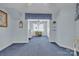 Comfortable bedroom with blue carpet, window with curtains, and adjacent study at 129 Renaissance Pl, Statesville, NC 28625