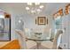 Bright dining room with a glass table set and natural light, perfect for Gathering meals at 129 Renaissance Pl, Statesville, NC 28625