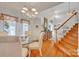 Elegant dining room with chandelier, hardwood floors, and staircase at 129 Renaissance Pl, Statesville, NC 28625
