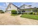 Side view of home with three-car garage, tidy landscaping, and inviting front porch at 129 Renaissance Pl, Statesville, NC 28625