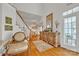 Elegant foyer with hardwood floors, staircase, decorative mirror, and a glimpse into the dining area at 129 Renaissance Pl, Statesville, NC 28625