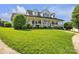 Charming two-story home with a welcoming, spacious front porch and lush green lawn at 129 Renaissance Pl, Statesville, NC 28625