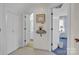 Bright hallway with closet, bathroom, and bedroom access, complete with neutral carpet and painted walls at 129 Renaissance Pl, Statesville, NC 28625