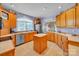 Spacious kitchen with stainless steel appliances, tile flooring and center island at 129 Renaissance Pl, Statesville, NC 28625