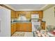 Kitchen with tile flooring, wood cabinets, and dining area at 129 Renaissance Pl, Statesville, NC 28625