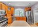 Functional kitchen featuring stainless steel appliances and ample wood cabinetry at 129 Renaissance Pl, Statesville, NC 28625