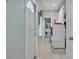 Well-lit laundry room with white appliances, cabinetry, tiled floors, and an exterior door at 129 Renaissance Pl, Statesville, NC 28625