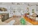 Spacious living room with fireplace, built-in shelving, hardwood floors, piano, and high ceilings at 129 Renaissance Pl, Statesville, NC 28625