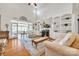 Bright living room with hardwood floors, built-in bookshelves, fireplace, and access to another room at 129 Renaissance Pl, Statesville, NC 28625