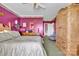 Comfortable main bedroom with a large bed, wooden armoire, dresser, and carpeted floor at 129 Renaissance Pl, Statesville, NC 28625
