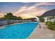 Sparkling in-ground pool with a nearby gazebo, enclosed by a white picket fence at 129 Renaissance Pl, Statesville, NC 28625