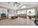 Bright sunroom with tile flooring, large windows offering a view, and comfortable seating at 129 Renaissance Pl, Statesville, NC 28625