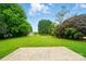Lush backyard with an expansive lawn, mature trees, and privacy offering a serene outdoor experience at 138 Montibello Dr, Mooresville, NC 28117