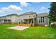 A well-maintained backyard, with a gray house, a patio and green lawn, perfect for outdoor activities at 138 Montibello Dr, Mooresville, NC 28117