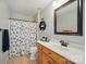 Bathroom features a vanity with wood cabinets, a framed mirror and a tub and shower combo at 138 Montibello Dr, Mooresville, NC 28117