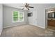Bedroom featuring a window for natural light, ceiling fan and an ensuite bathroom entrance at 138 Montibello Dr, Mooresville, NC 28117