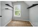 Bright bedroom with built-in shelving and a window offering natural light and a view at 138 Montibello Dr, Mooresville, NC 28117