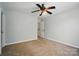 Bedroom featuring a ceiling fan, neutral walls and carpet and an ensuite bathroom entrance at 138 Montibello Dr, Mooresville, NC 28117