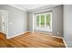 Bedroom with hardwood floors, bright window, and white trim at 138 Montibello Dr, Mooresville, NC 28117