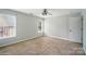 Bedroom with tan carpet, a ceiling fan and two windows at 138 Montibello Dr, Mooresville, NC 28117