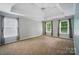 Spacious bedroom with carpet, many windows and curtains providing natural light and outside views at 138 Montibello Dr, Mooresville, NC 28117