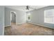 Spacious bedroom with neutral carpet, ceiling fan, and two windows at 138 Montibello Dr, Mooresville, NC 28117
