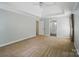 Bedroom featuring a tray ceiling, neutral walls and carpet and an ensuite bathroom entrance at 138 Montibello Dr, Mooresville, NC 28117