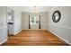Dining room with wood floors, a chandelier, neutral walls, and a window for natural light at 138 Montibello Dr, Mooresville, NC 28117