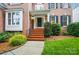 Inviting entrance with red brick steps, manicured landscaping, and classic architectural details at 138 Montibello Dr, Mooresville, NC 28117