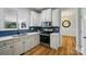 Modern kitchen boasting stainless steel appliances, white cabinets, and a blue tiled backsplash at 138 Montibello Dr, Mooresville, NC 28117