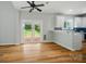 Bright living room featuring a sliding glass door to deck and breakfast bar to kitchen at 138 Montibello Dr, Mooresville, NC 28117