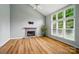 Spacious living room with a cozy stone fireplace, large windows, vaulted ceilings and light hardwood floors at 138 Montibello Dr, Mooresville, NC 28117