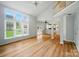 Open concept living area with large windows, vaulted ceilings, and views of the kitchen at 138 Montibello Dr, Mooresville, NC 28117