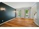 Living room with hardwood floors, two windows, accent wall, and staircase at 138 Montibello Dr, Mooresville, NC 28117