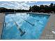 Community pool with clear water, marked lanes and seating areas. Reflected are the sky and nearby cabanas at 138 Montibello Dr, Mooresville, NC 28117