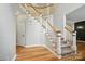 Carpeted staircase with white wood rails and hardwood floors at 138 Montibello Dr, Mooresville, NC 28117