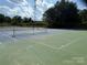 Community tennis courts with nets in place, ready for a match, with lush green trees in the background at 138 Montibello Dr, Mooresville, NC 28117