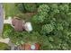 Aerial view of a brick house with a pool surrounded by lush greenery, and a large lot at 144 Sea Trail Dr, Mooresville, NC 28117