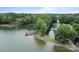 Aerial view of boat ramp, lake, pier, and surrounding lush greenery at 144 Sea Trail Dr, Mooresville, NC 28117