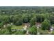 Expansive aerial view of a home surrounded by lush greenery and a refreshing pool at 144 Sea Trail Dr, Mooresville, NC 28117