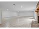 Large, unfinished basement area with tile flooring and a brick fireplace at 144 Sea Trail Dr, Mooresville, NC 28117