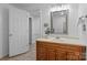 Bright bathroom featuring a wood vanity, a square mirror, and tile flooring at 144 Sea Trail Dr, Mooresville, NC 28117