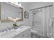 Bright bathroom featuring double sinks, a marble countertop, and a bathtub with a shower at 144 Sea Trail Dr, Mooresville, NC 28117