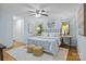 Bright bedroom featuring a ceiling fan, hardwood floors, and a large bed with stylish decorations at 144 Sea Trail Dr, Mooresville, NC 28117