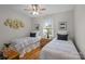 Charming bedroom with two twin beds, hardwood floors, and decorative artwork adorning the walls at 144 Sea Trail Dr, Mooresville, NC 28117