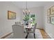 Formal dining room with stylish chandelier, neutral paint, and comfortable seating for elegant meals at 144 Sea Trail Dr, Mooresville, NC 28117