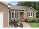 Charming brick home with lush landscaping, a sidewalk, and dark green shutters at 144 Sea Trail Dr, Mooresville, NC 28117