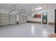 Spacious garage with three car garage doors and epoxy flooring and bonus storage at 144 Sea Trail Dr, Mooresville, NC 28117
