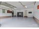 Spacious two car garage with epoxy flooring, white walls, and storage cabinets; offers ample storage and workspace at 144 Sea Trail Dr, Mooresville, NC 28117