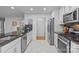 Modern kitchen featuring granite countertops, stainless steel appliances, and white cabinets with stylish backsplash at 144 Sea Trail Dr, Mooresville, NC 28117